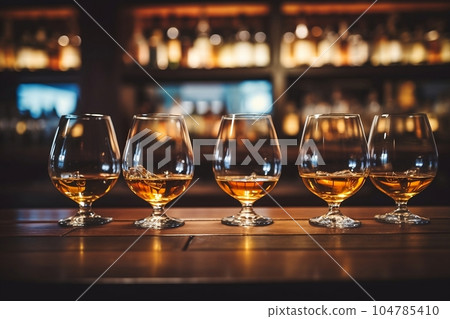 Glasses of whiskey with ice on the bar Glasses of whiskey with ice on the bar 104785410