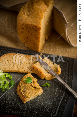 homemade meat pate with bread on a wooden table 104785533