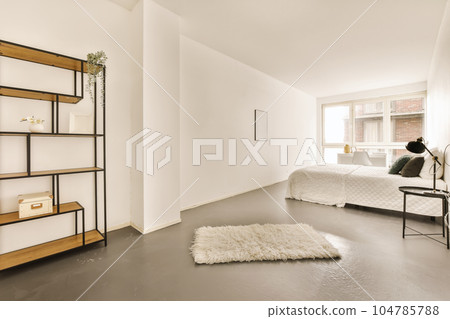 a bedroom with a bed and shelves on the wall next to the bed is a white rug that looks like sheepskin a bedroom with a bed and shelves on the wall next to the bed is a white rug that looks like sheepskin 104785788