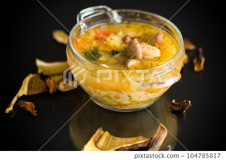 vegetarian vegetable soup with porcini mushrooms in a glass bowl 104785817