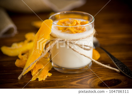 homemade sweet yogurt in a glass with mango 104786311