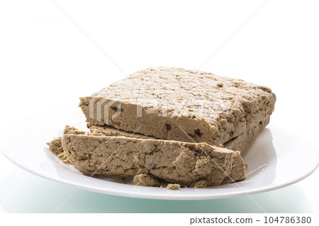 piece of sweet halva on white background piece of sweet halva on white background 104786380