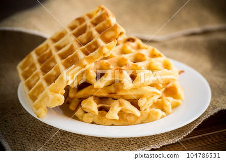 sweet cooked aromatic Belgian waffles in a plate 104786531
