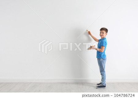 Little child painting on white wall indoors. Space for text Little child painting on white wall indoors. Space for text 104786724