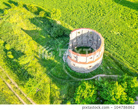 Ruins of old rural windmill in Pricovy near Sedlcany. The largest Dutch type mill. Czech Republic. Aerial view from drone. 104786862