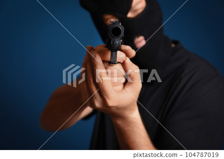 Emotional courier with damaged cardboard box on blue background, closeup. Poor quality delivery 104787019