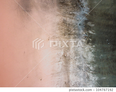 A bird's eye view of a red salt lake and black earth, captured by a drone. A bird's eye view of a red salt lake and black earth, captured by a drone. 104787192