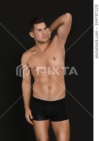 Handsome man in underwear on black background 104787228