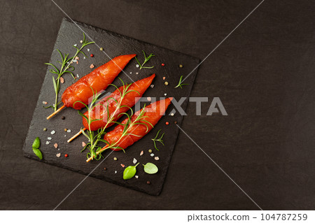 Ogranic food,healthy eating.Fresh raw marinated chicken meat skewers iner fillet with fresh herbs on a black background.Top view.Copy space.Chicken fillet inner skewers.Food concept.Food for retail. 104787259