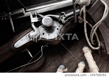 Flintlock musket with powder flask and led bullets. Flintlock musket with powder flask and led bullets. 104788562