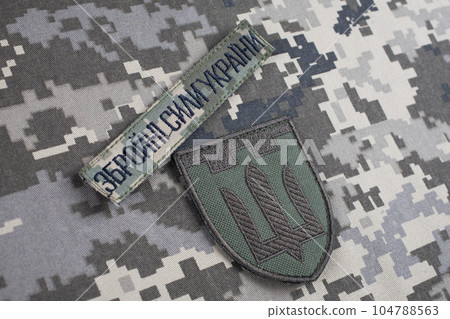 KYIV, UKRAINE - October 6, 2022. Russian invasion in Ukraine 2022. Territorial Defence Forces of Ukraine uniform badge. Text in ukrainian - Armed Forces of Ukraine. 104788563
