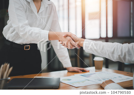 Business partnership meeting concept. Image business womans handshake. Successful businessmen handshaking after good deal. 104790580