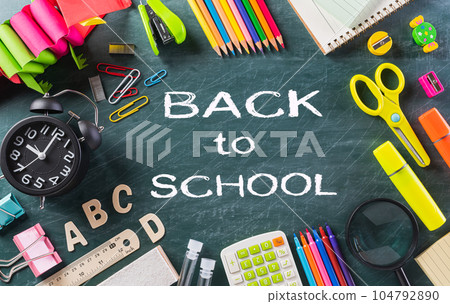 Education or back to school Concept. Top view of Colorful school supplies with books, color pencils, calculator, pen cutter clips chalkboard background. Education or back to school Concept. Top view of Colorful school supplies with books, color pencils, calculator, pen cutter clips chalkboard background. 104792890