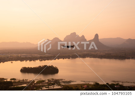 The drone high resolution digital camera flying with mountain,river view and beautiful sunset 104793105