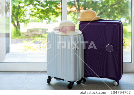 suitcase and straw hat suitcase and straw hat 104794702