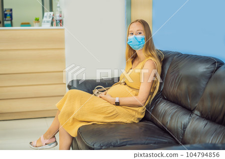 young woman in the waiting room interview sitting on sofa in corridor of dentist office or reception modern medical center while doctor's appointment. using mobile phone fills information or resumes young woman in the waiting room interview sitting on sofa in corridor of dentist office or reception modern medical center while doctor's appointment. using mobile phone fills information or resumes 104794856