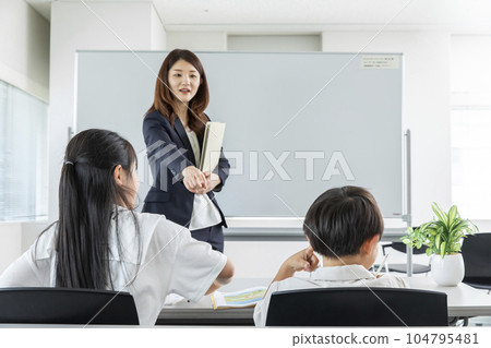 Lecturer and student at cram school 104795481