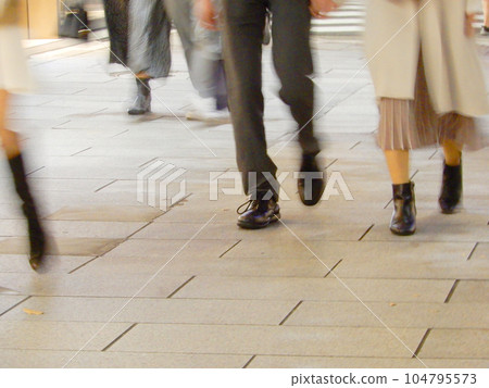 People walking on the sidewalk in the city at night (blur) 104795573