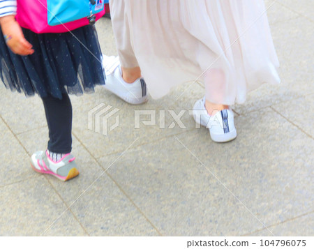 Mother daughter walking in the park Mother daughter walking in the park 104796075