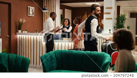 Company executives upgrading holiday package deal, writing digital signature on tablet. Professional work partners on business trip upscaling hotel room amenities, helped by helpful receptionist Company executives upgrading holiday package deal, writing digital signature on tablet. Professional work partners on business trip upscaling hotel room amenities, helped by helpful receptionist 104797248