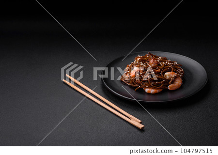 Delicious fresh buckwheat noodles with boiled tiger prawns, salt, spices and mushrooms 104797515