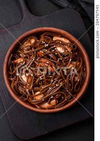 Delicious fresh buckwheat noodles with boiled tiger prawns, salt, spices and mushrooms Delicious fresh buckwheat noodles with boiled tiger prawns, salt, spices and mushrooms 104797545