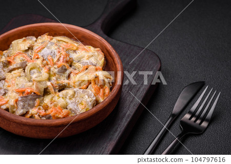 Delicious boiled beef or pork tongue sliced with carrots, onions, sour cream and spices 104797616