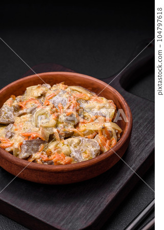Delicious boiled beef or pork tongue sliced with carrots, onions, sour cream and spices 104797618