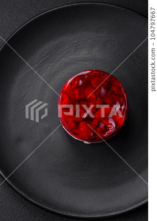 Delicious fresh sweet cheesecake cake with berries and red color jelly 104797667