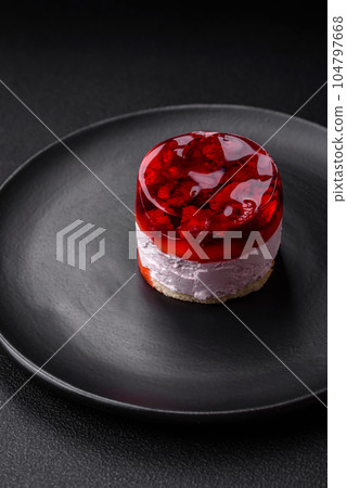 Delicious fresh sweet cheesecake cake with berries and red color jelly 104797668