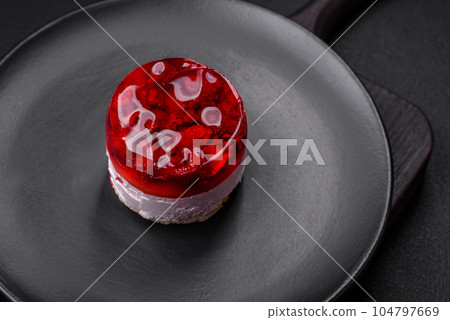 Delicious fresh sweet cheesecake cake with berries and red color jelly Delicious fresh sweet cheesecake cake with berries and red color jelly 104797669