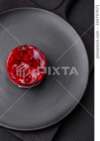 Delicious fresh sweet cheesecake cake with berries and red color jelly Delicious fresh sweet cheesecake cake with berries and red color jelly 104797671
