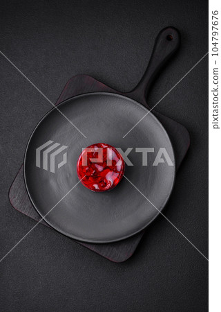 Delicious fresh sweet cheesecake cake with berries and red color jelly 104797676