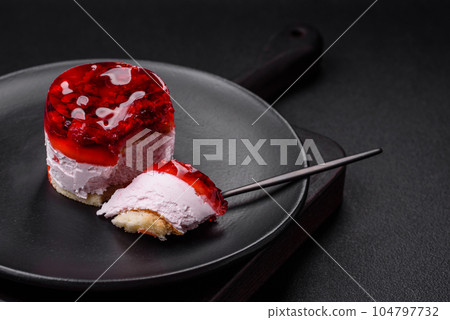 Delicious fresh sweet cheesecake cake with berries and red color jelly 104797732
