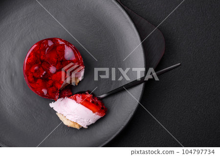 Delicious fresh sweet cheesecake cake with berries and red color jelly 104797734