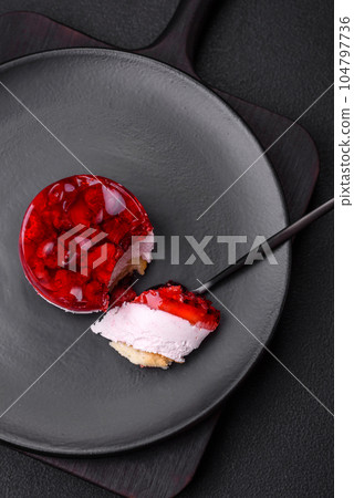 Delicious fresh sweet cheesecake cake with berries and red color jelly 104797736