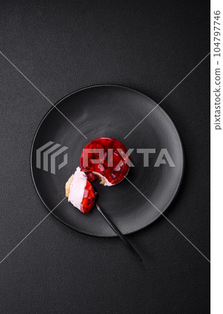 Delicious fresh sweet cheesecake cake with berries and red color jelly 104797746