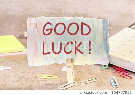 A note on paper with good luck wishes on the table secured with a clothespin A note on paper with good luck wishes on the table secured with a clothespin 104797931