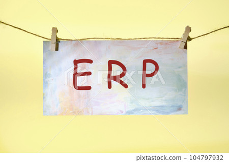 ERP text on colored paper hanging on a rope with clothespins. concept for enterprise resource planning with icon of inventory, financials, hrm, production, service, purchasing, and mrp ERP text on colored paper hanging on a rope with clothespins. concept for enterprise resource planning with icon of inventory, financials, hrm, production, service, purchasing, and mrp 104797932