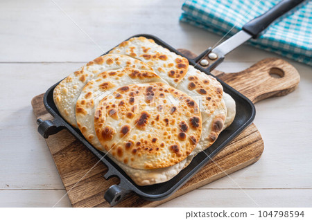 Unwrapped gyoza baked in a hot sandwich maker Unwrapped gyoza baked in a hot sandwich maker 104798594