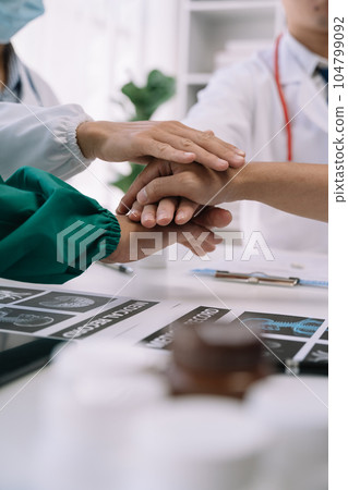 Doctors shaking hands, working together as a team at the hospital. Doctors shaking hands, working together as a team at the hospital. 104799092