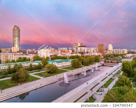 Embankment of the central pond and musical fountain. The historic center of the city of Yekaterinburg, Russia, Aerial View Embankment of the central pond and musical fountain. The historic center of the city of Yekaterinburg, Russia, Aerial View 104799347