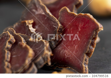 dried red beef meat on the kitchen table dried red beef meat on the kitchen table 104799516
