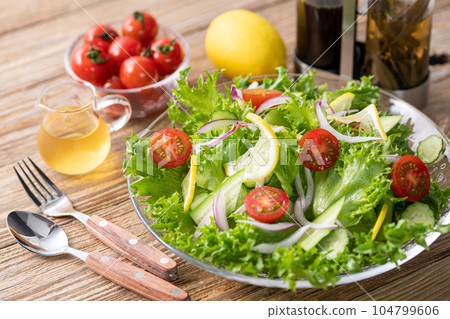 Colorful vegetable salad with delicious dressing (for healthy breakfast) barnwood background Colorful vegetable salad with delicious dressing (for healthy breakfast) barnwood background 104799606
