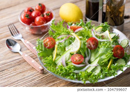 Colorful vegetable salad with delicious dressing (for healthy breakfast) barnwood background Colorful vegetable salad with delicious dressing (for healthy breakfast) barnwood background 104799607