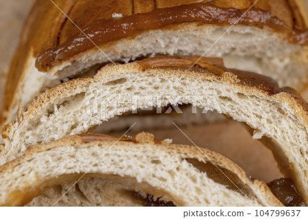 sliced soft fresh wheat pastries with golden crust 104799637