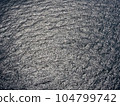 An aerial view of the open sea with textured surface of the water. 104799742