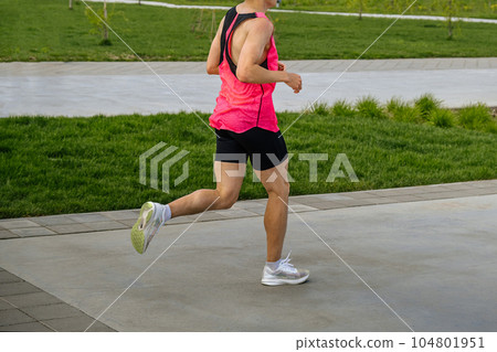 male athlete runner running marathon race in landscape park, summer sports event 104801951