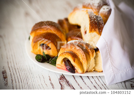 baked sweet homemade buns with plum inside 104803152