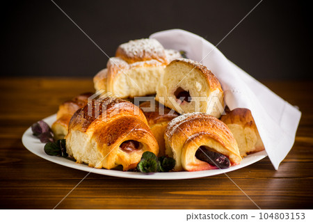 baked sweet homemade buns with plum inside 104803153